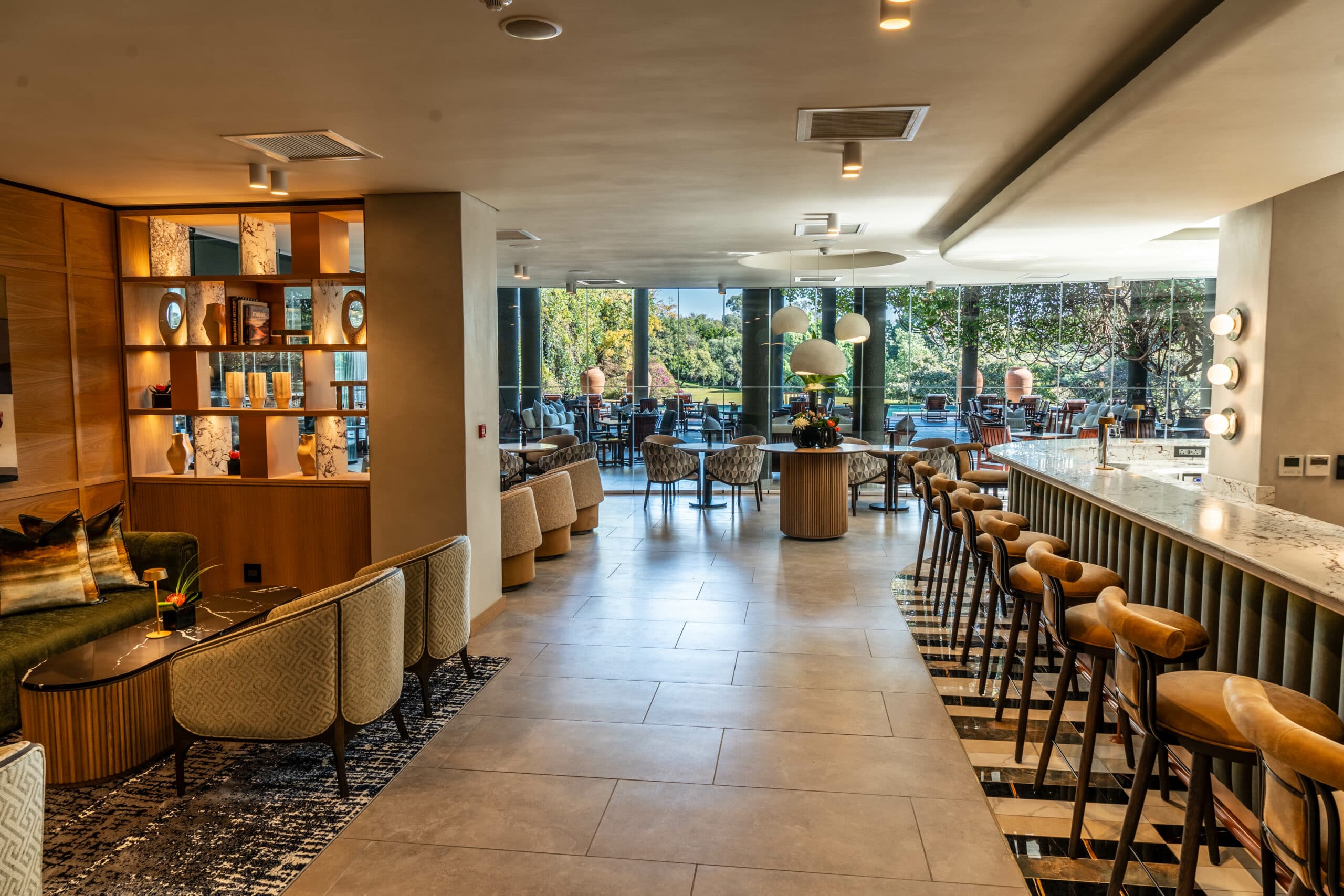 Olive Bar interior with garden views through glass doors